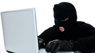 voleur masqué sur Internet en train de préparer une escroquerie au poker